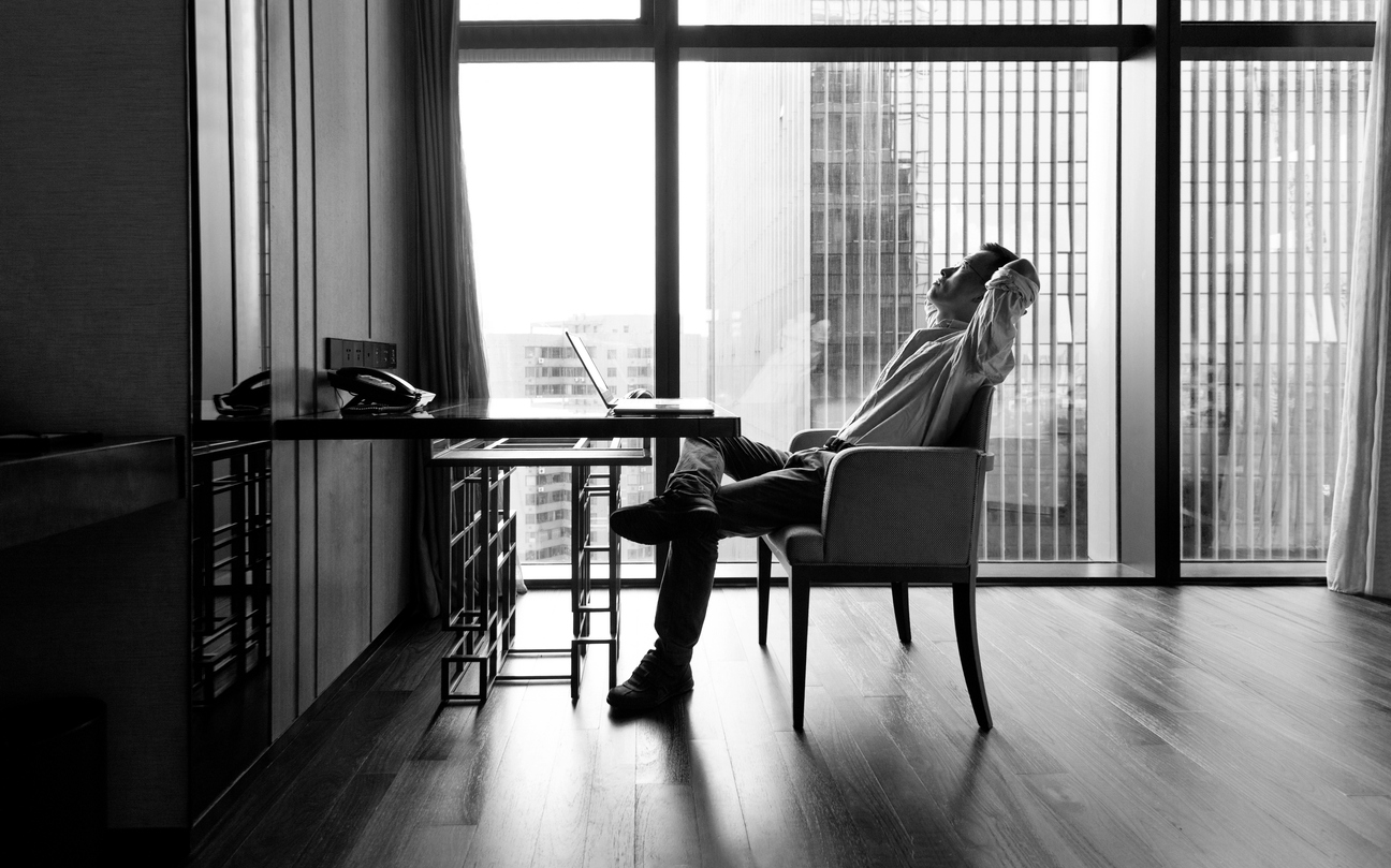 Businessman leaning on chair with hands behind head Officejob